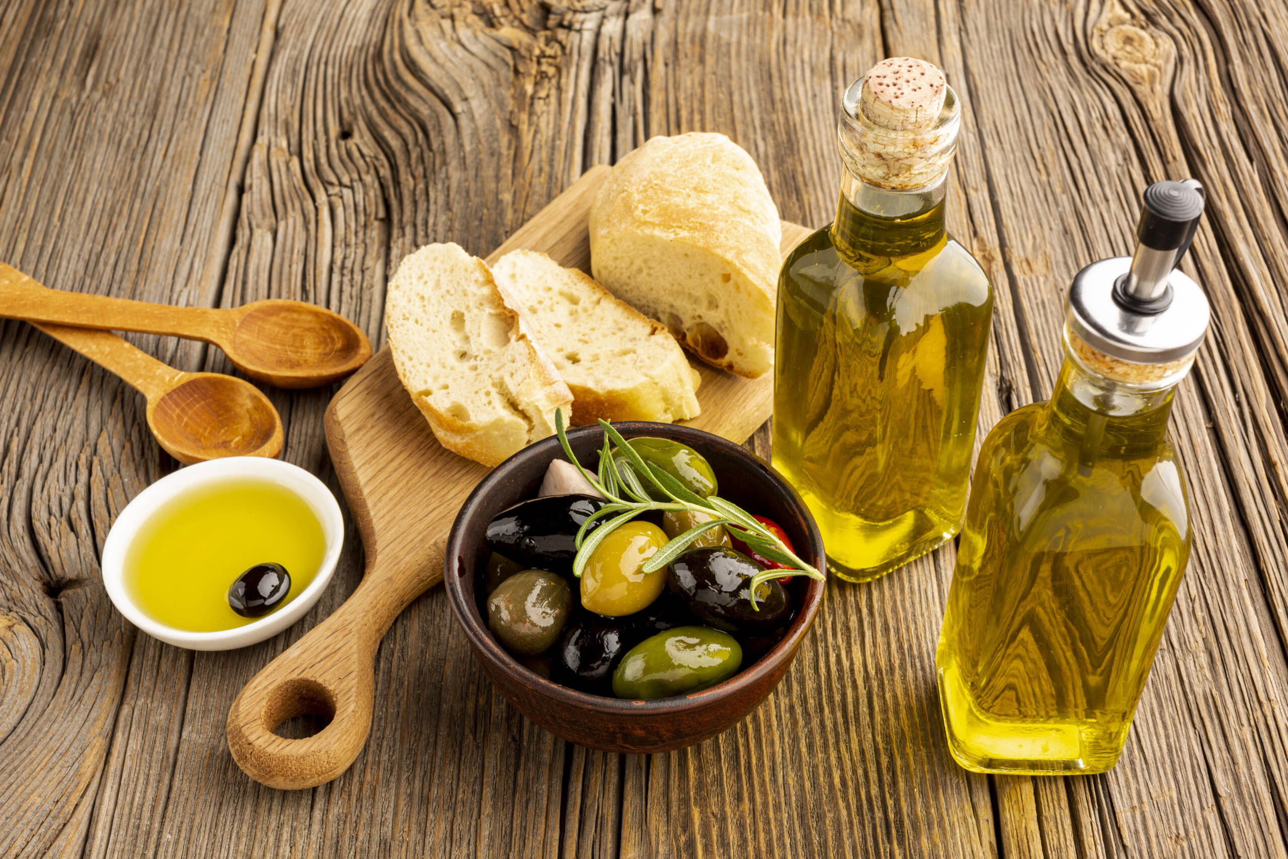 high-angle-olives-mix-bread-oil-bottles-scaled